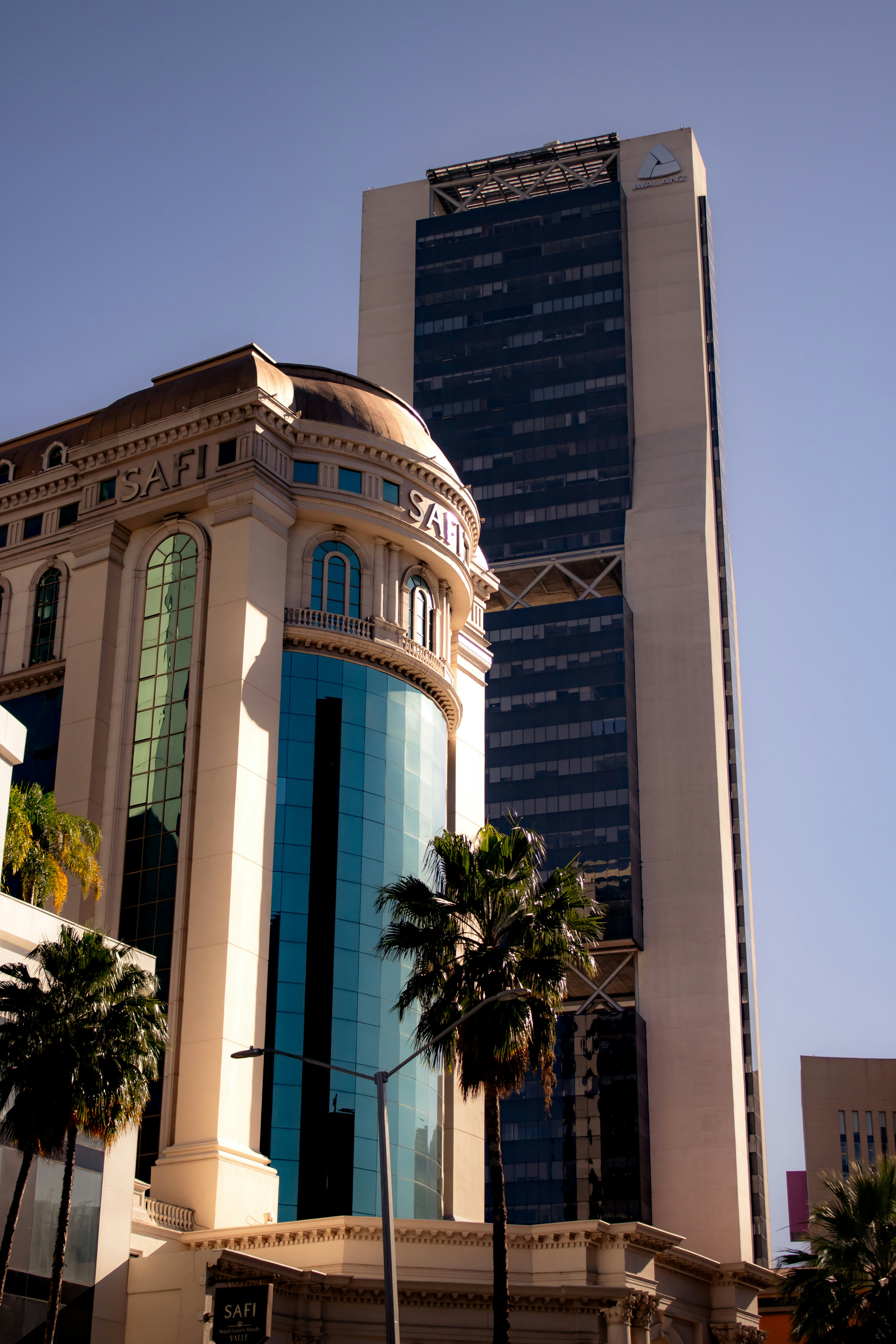 A tall building sitting next to a tall building photo – Free Building ...