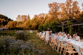 A group of people sitting at a long table