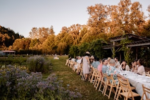 A group of people sitting at a long table