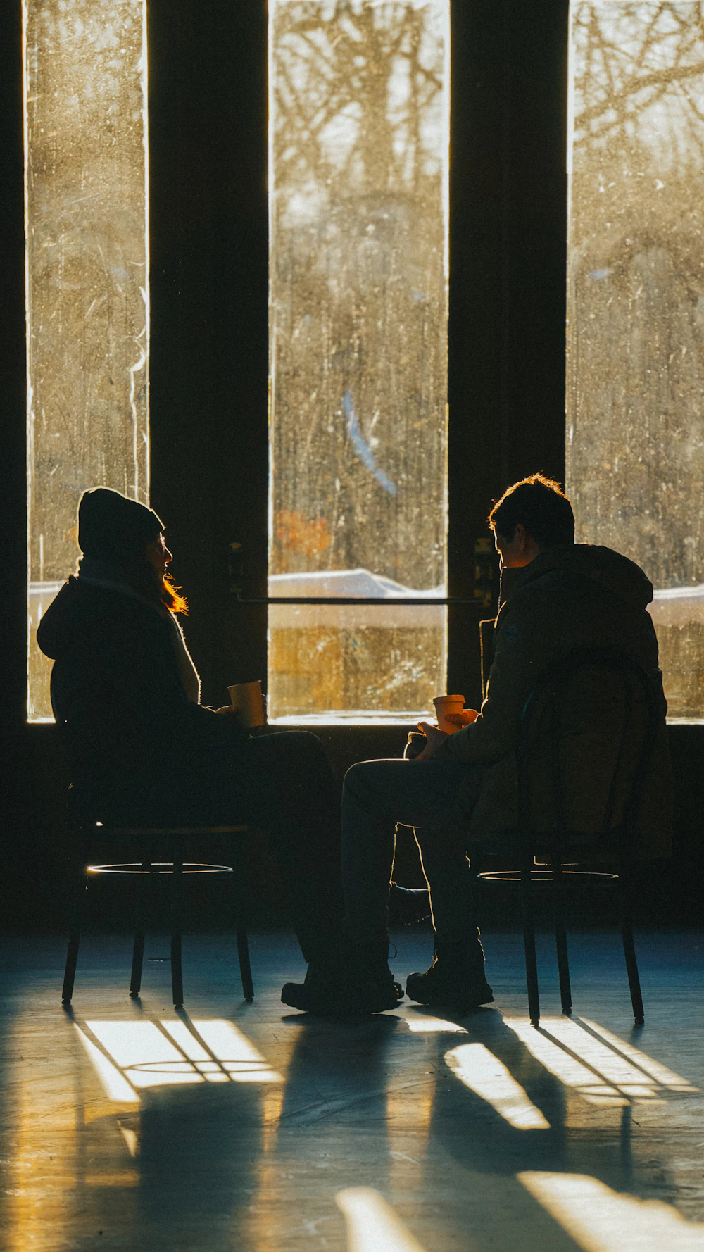 A calm, sunlit conversation by a window