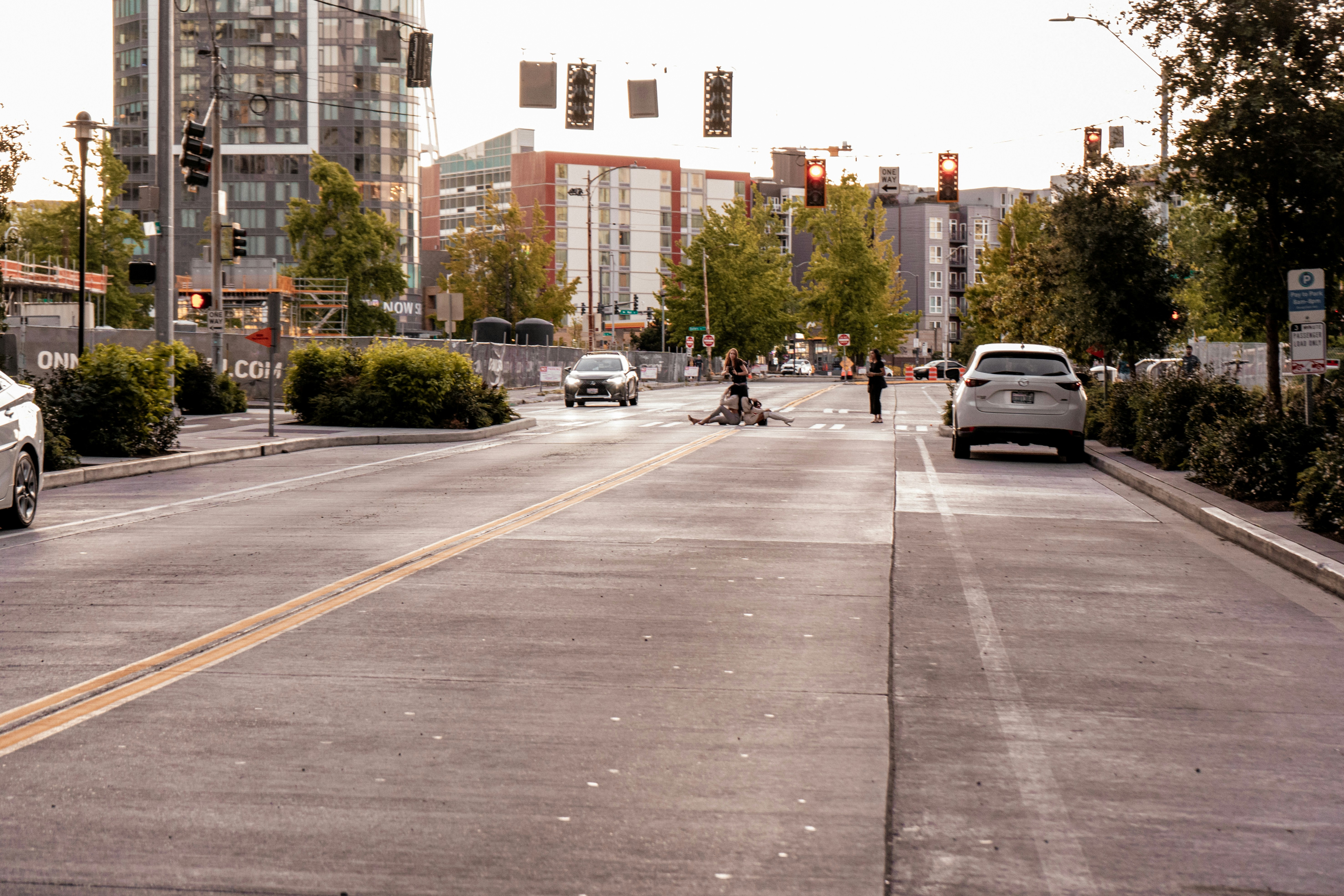 A city street with cars parked on the side of the road