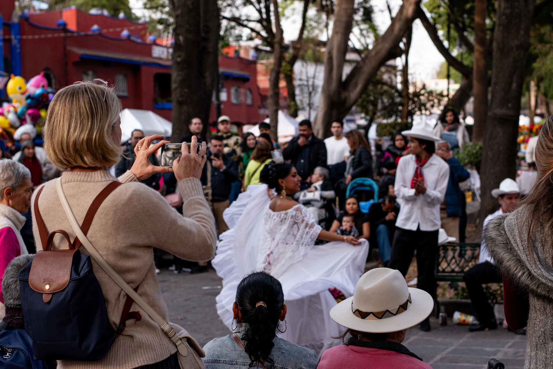 A crowd of people standing around each other