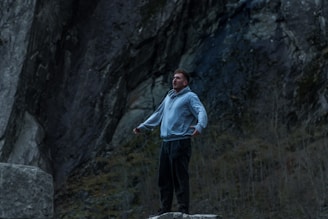 A man standing on top of a rock formation
