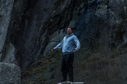 A man standing on top of a rock formation