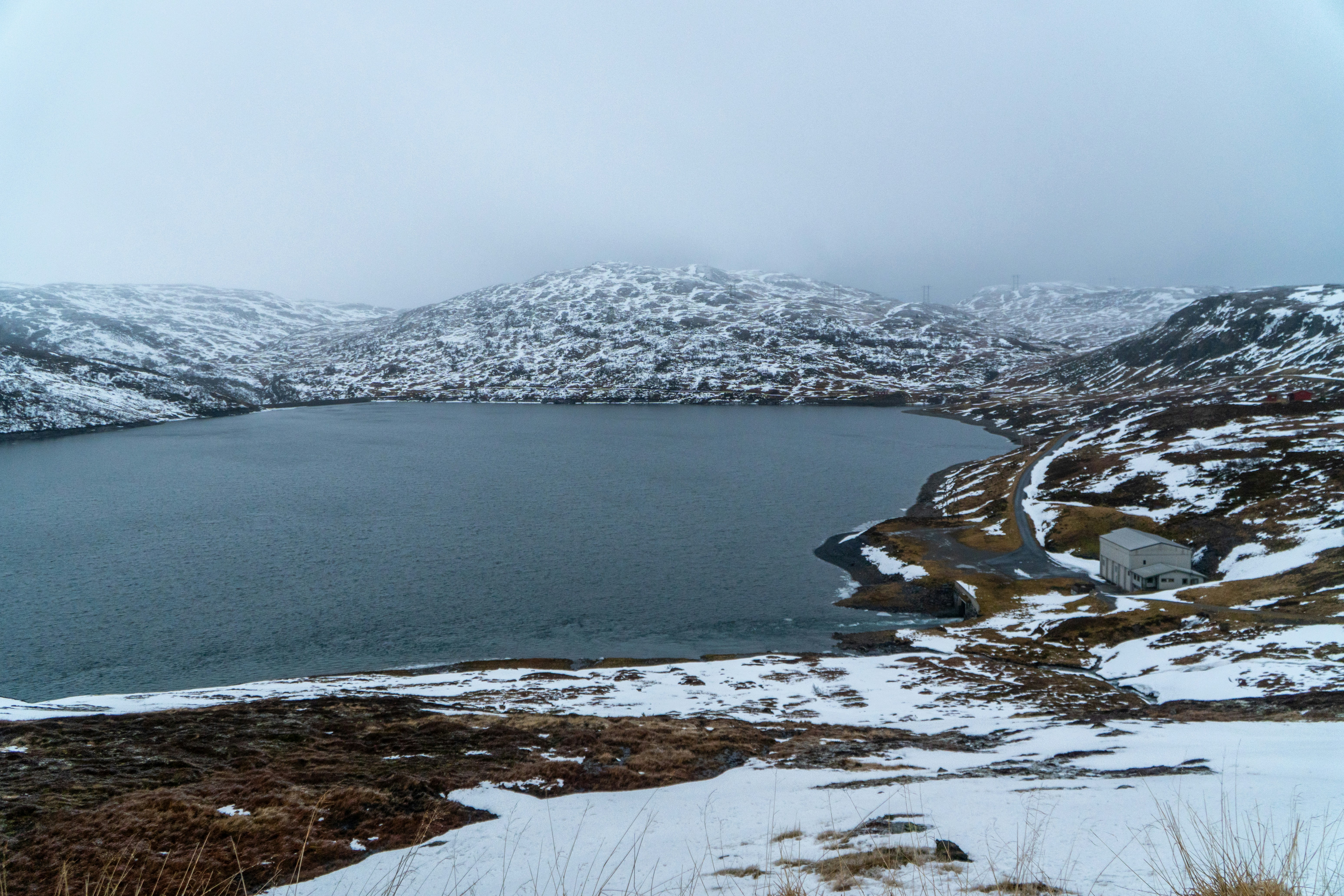 Målsetevatnet lake, surrounded by snowy hills.