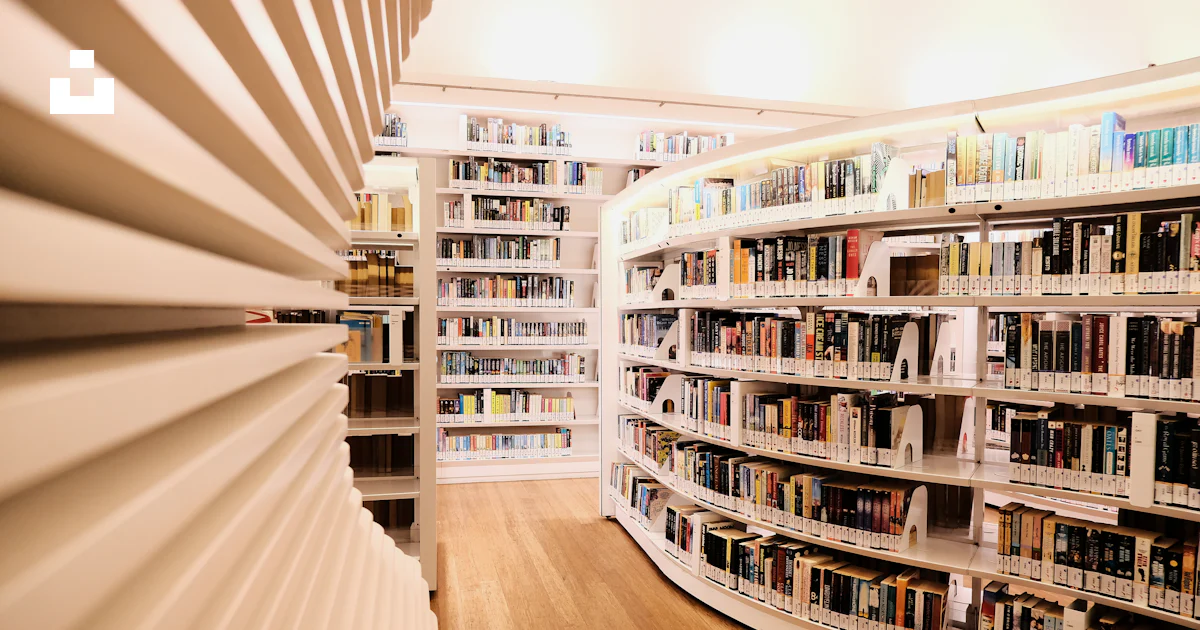 A library filled with lots of books and a spiral staircase photo – Free ...