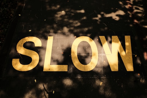 A close up of a street sign with trees in the background