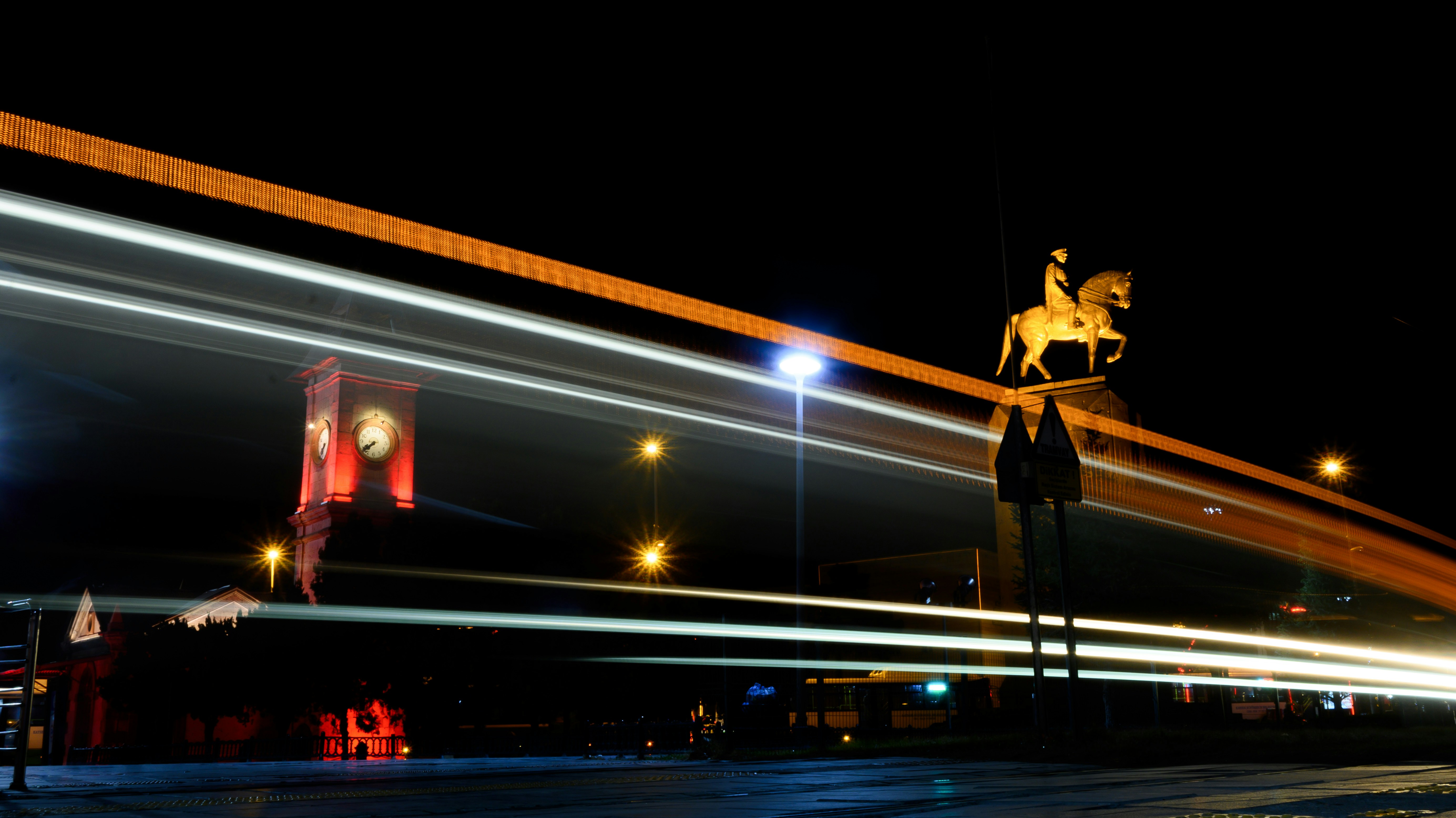 A blurry photo of a horse statue at night