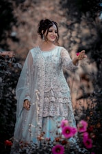 A woman standing in a field of flowers