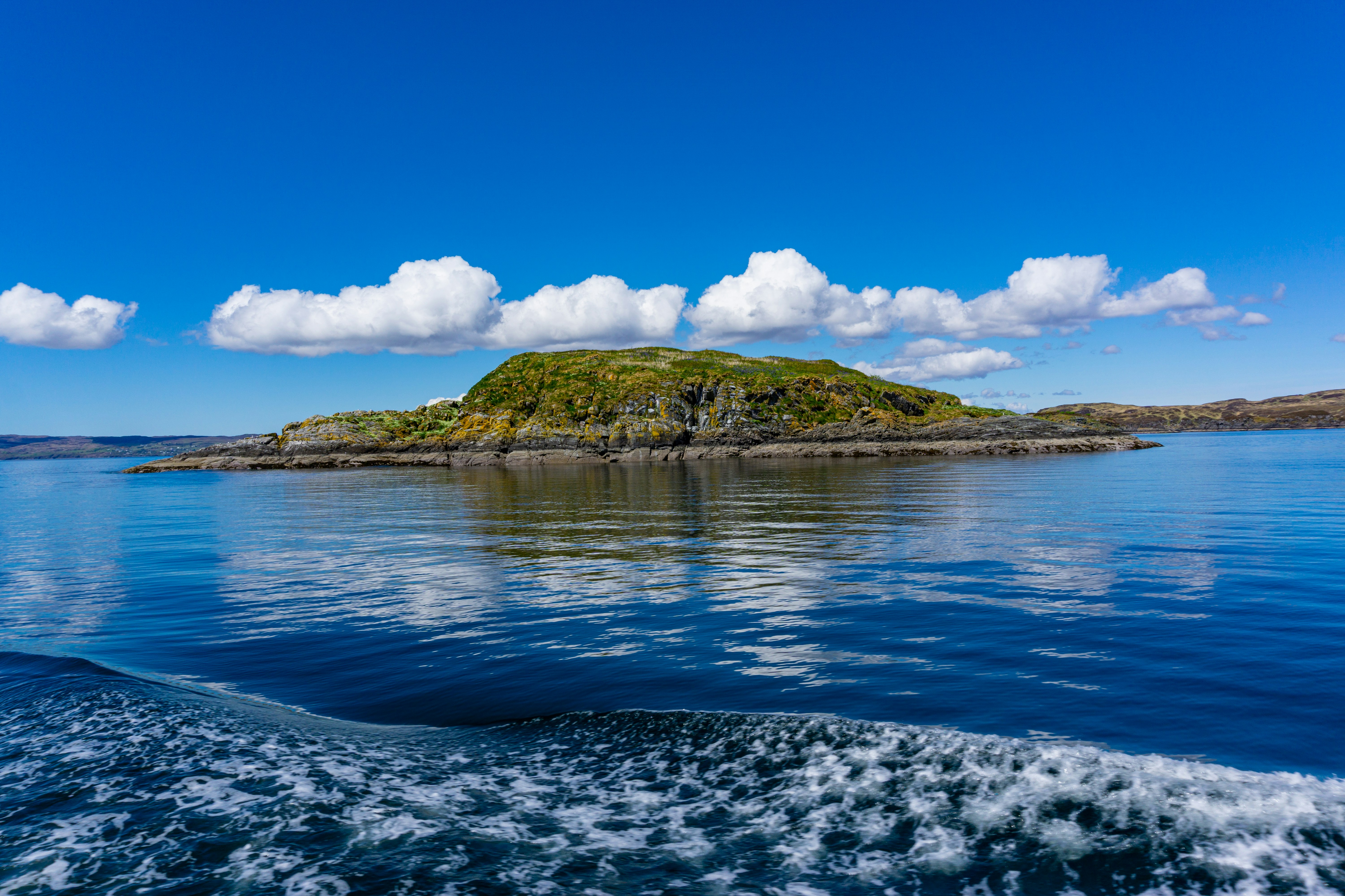 A small island in the middle of a body of water