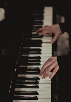 A person playing a piano in a dark room