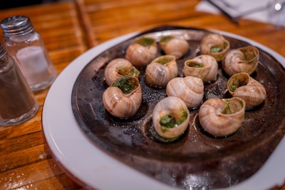 A white plate topped with lots of food on top of a wooden table