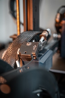 A close up of a machine with a metal object in the background