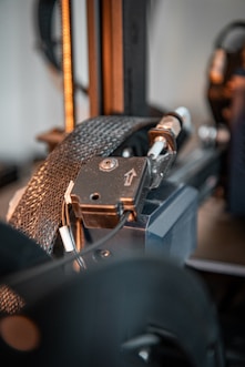 A close up of a machine with a metal object in the background