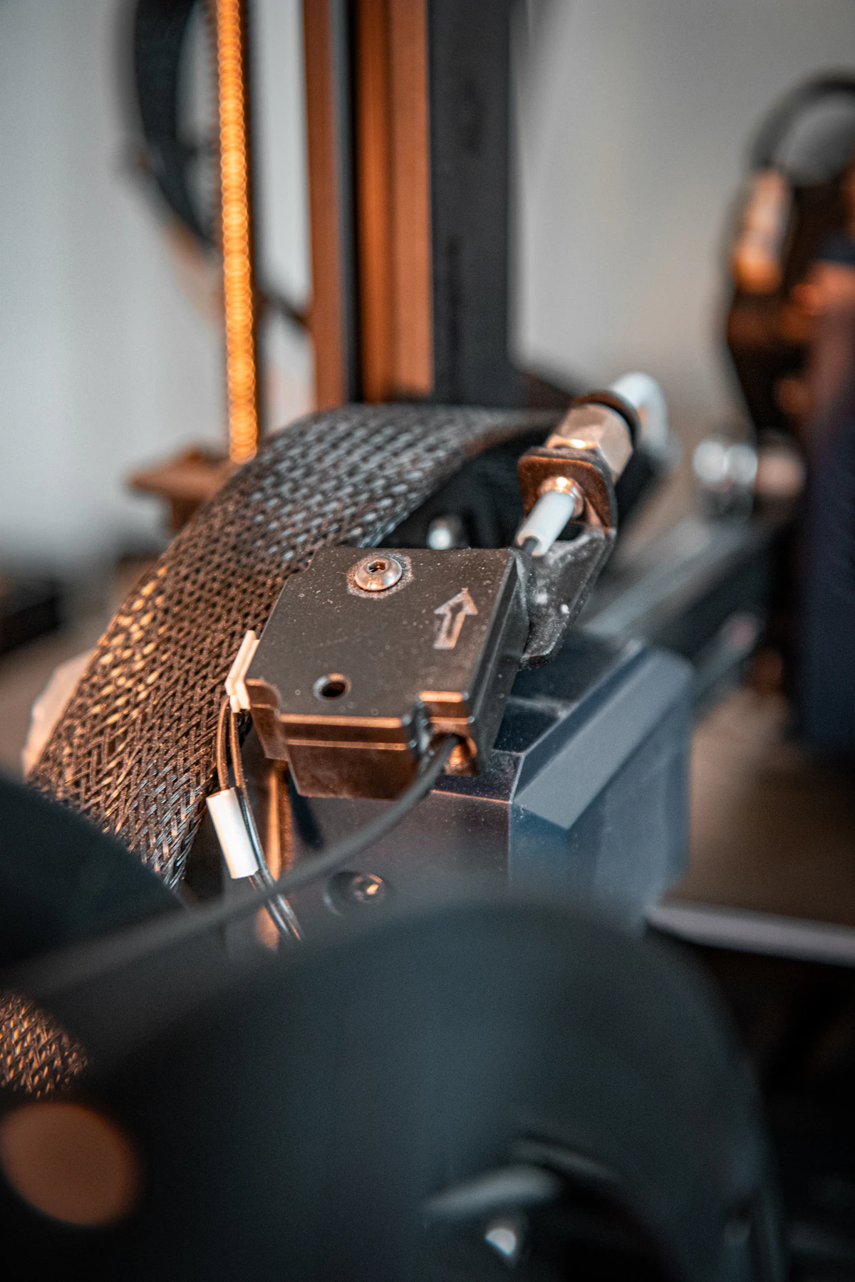 Close-up of a 3D printer toolhead and filament path