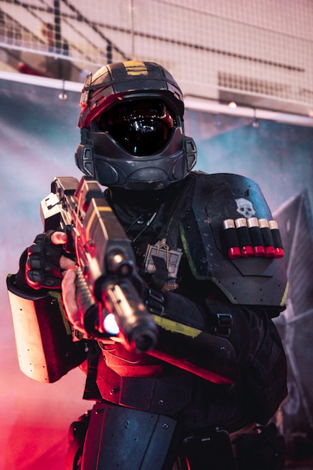 A man in a helmet holding a gun