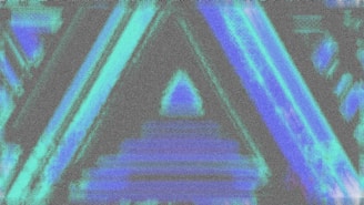 A blurry image of a triangle in blue and green