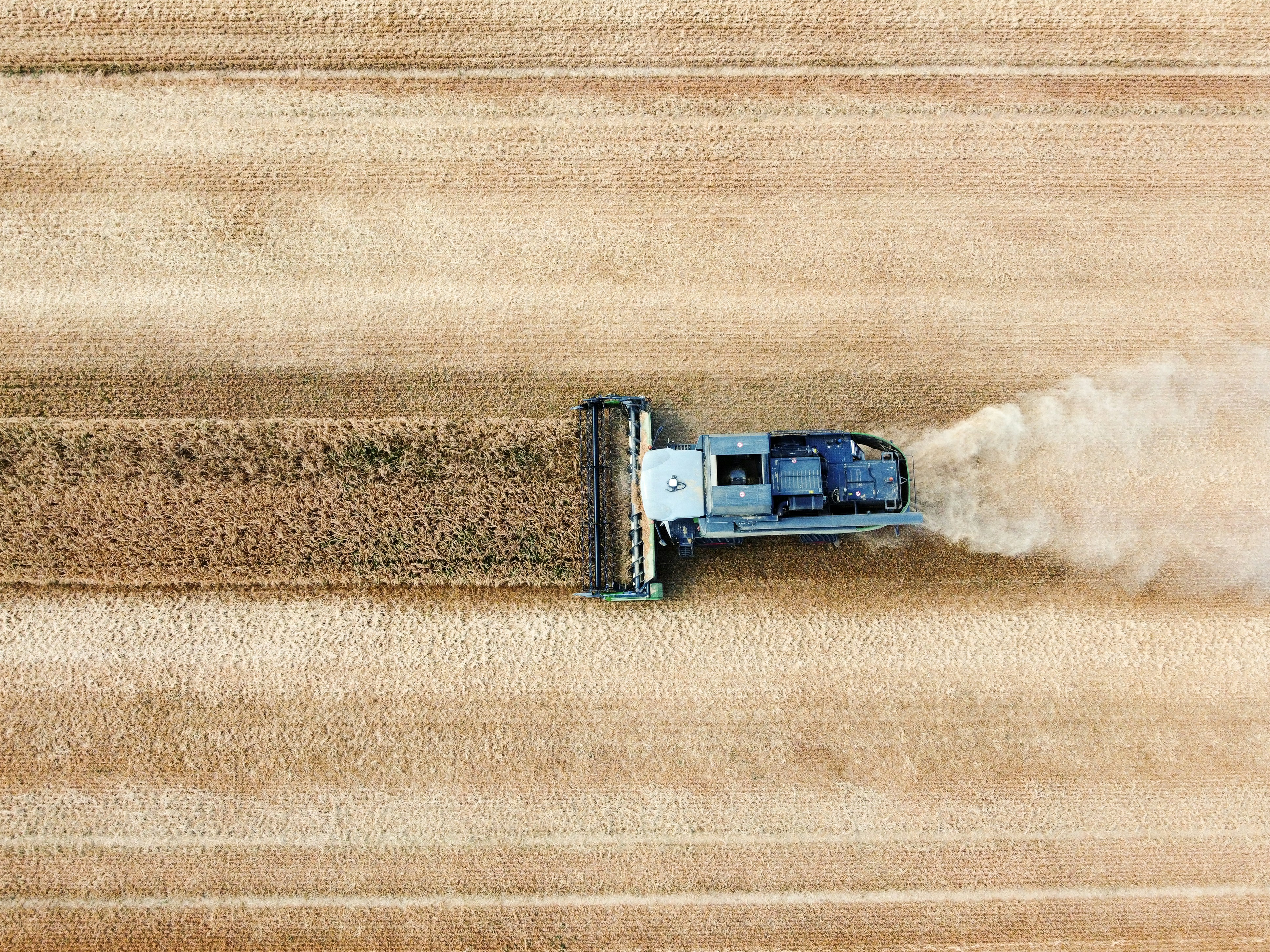 Aerial view of harvester working in agricultural field