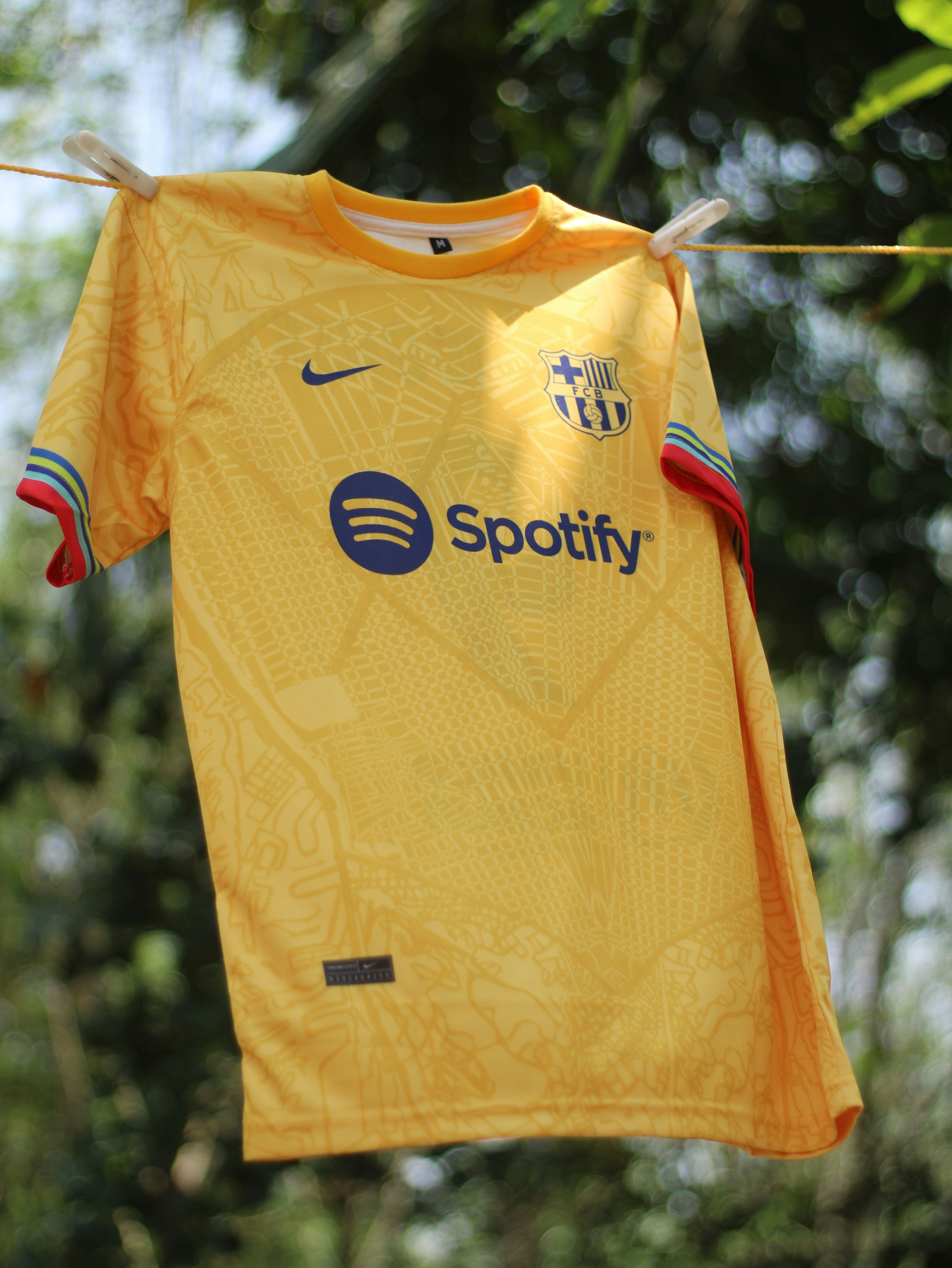 A soccer jersey hanging on a clothes line