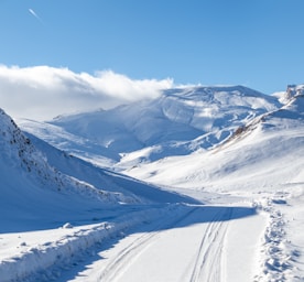 A person riding skis down a snow covered slope