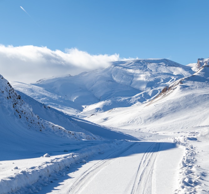 A person riding skis down a snow covered slope