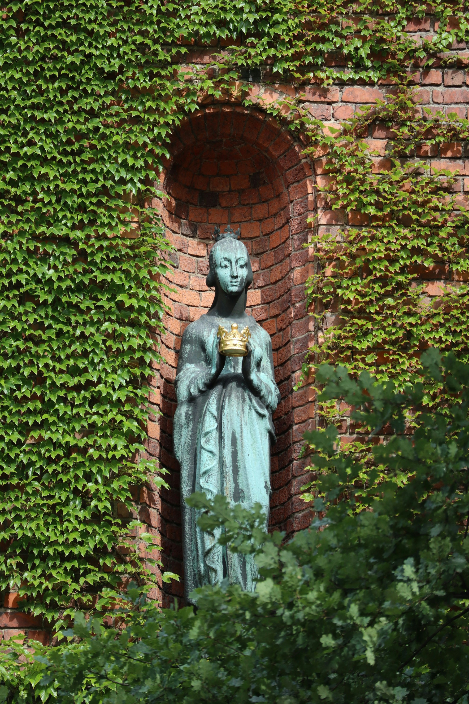 A statue of a woman holding a cup of coffee