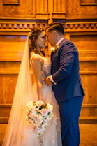 A bride and groom standing in front of a church alter