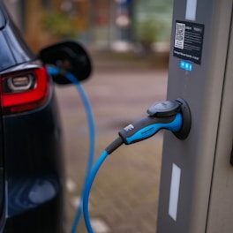An electric car plugged in to a charging station