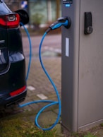 An electric car plugged in to a charging station