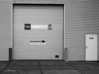 A black and white photo of a garage door