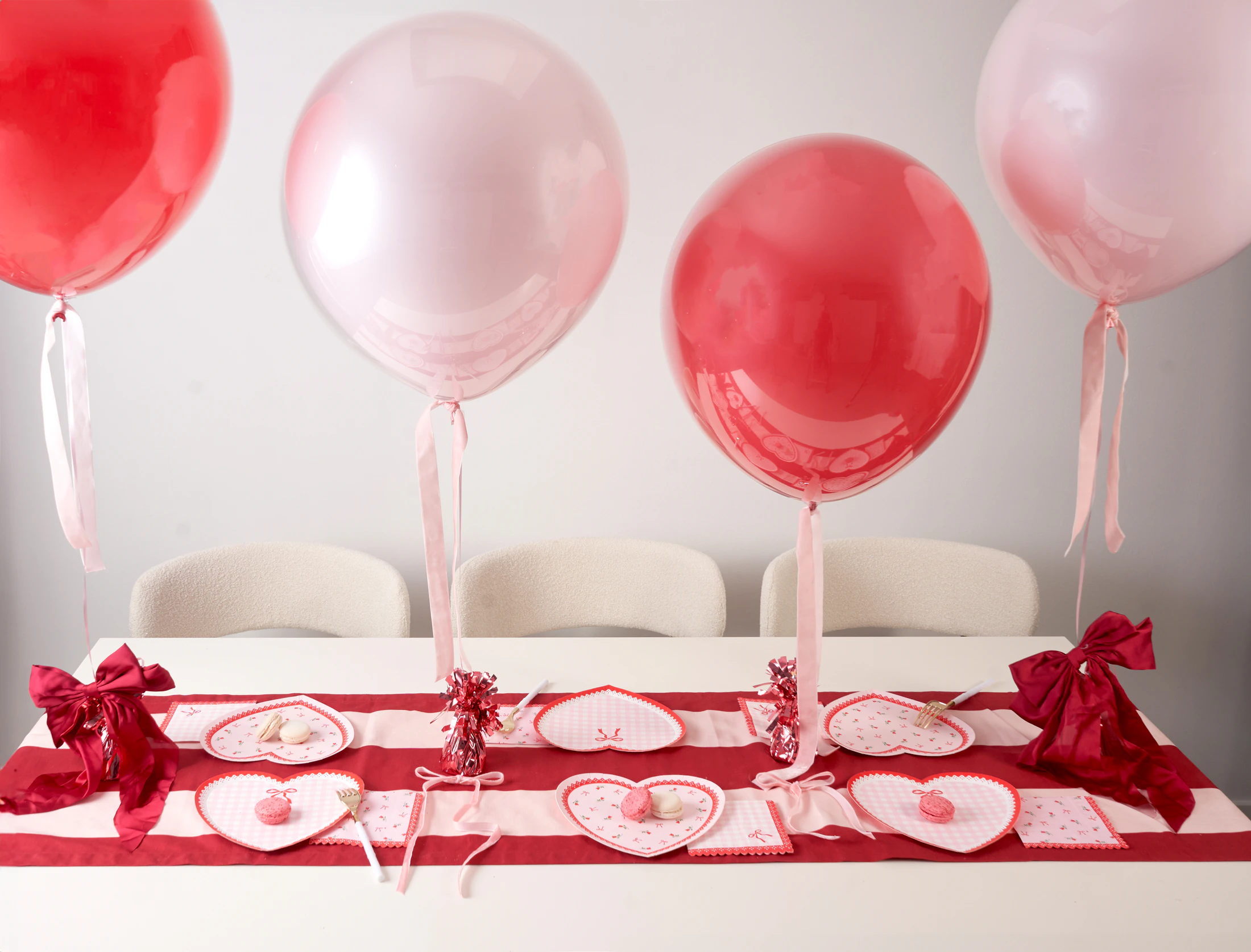 Colorful party table with coordinated balloons, tableware and festive celebration details