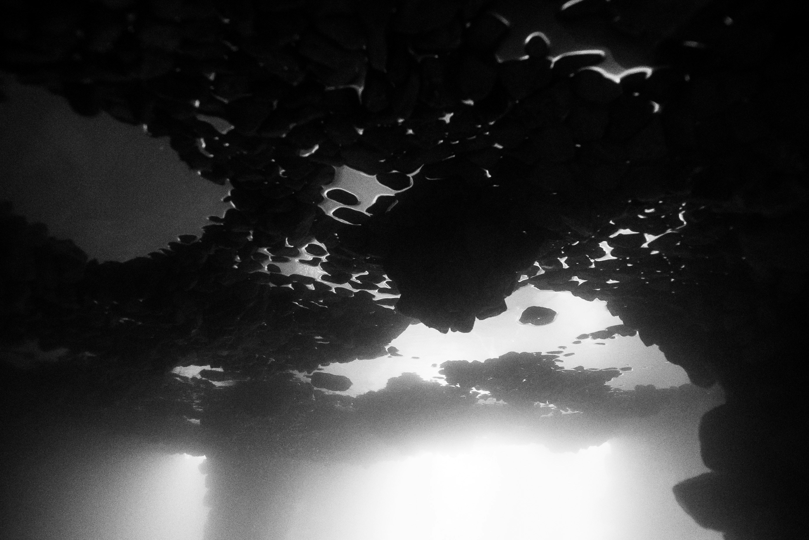 A black and white photo of a boat in the water