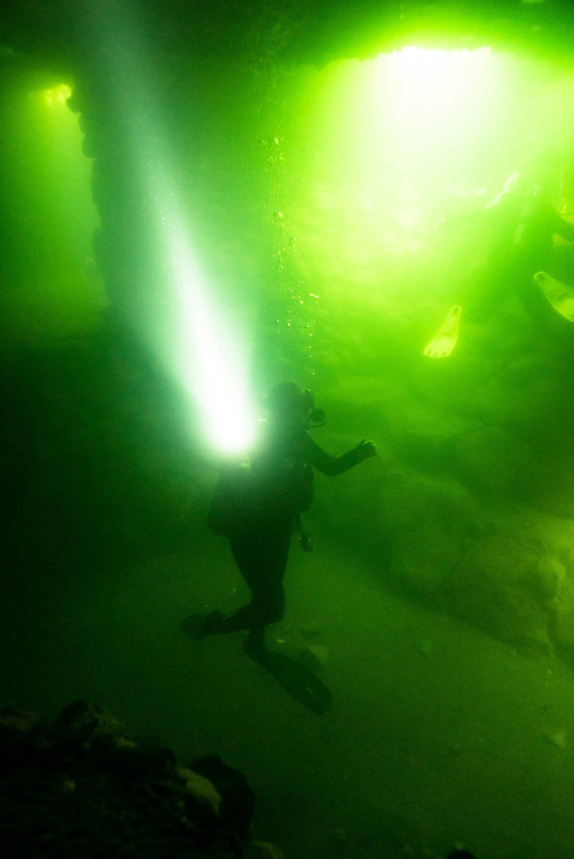 A person standing in front of a green light