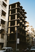 A tall building with a bunch of balconies on the side of it