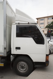 A white truck parked in a parking lot