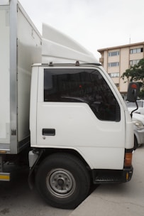 A white truck parked in a parking lot