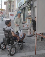 A man in a wheel chair on a city street