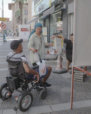 A man in a wheel chair on a city street