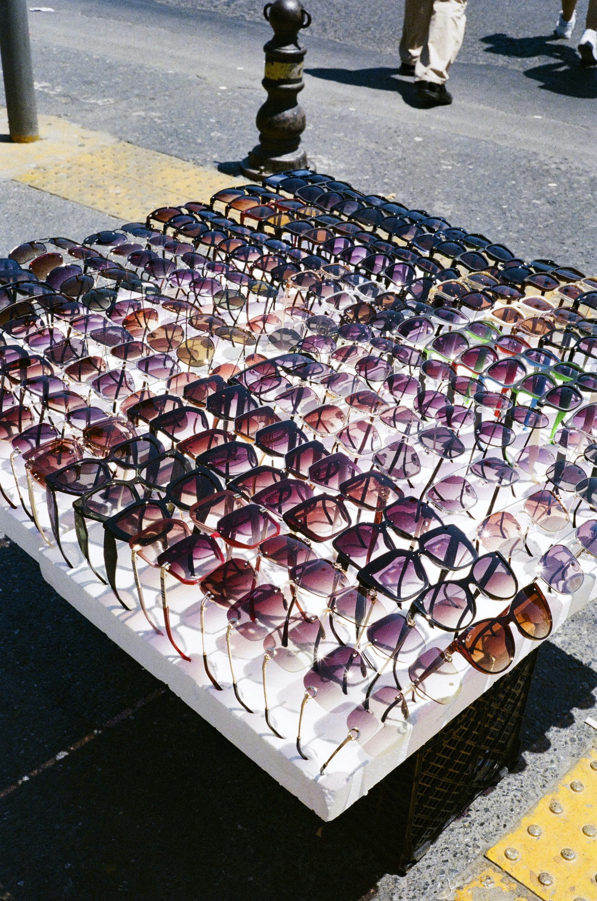 A table with many pairs of sunglasses on it