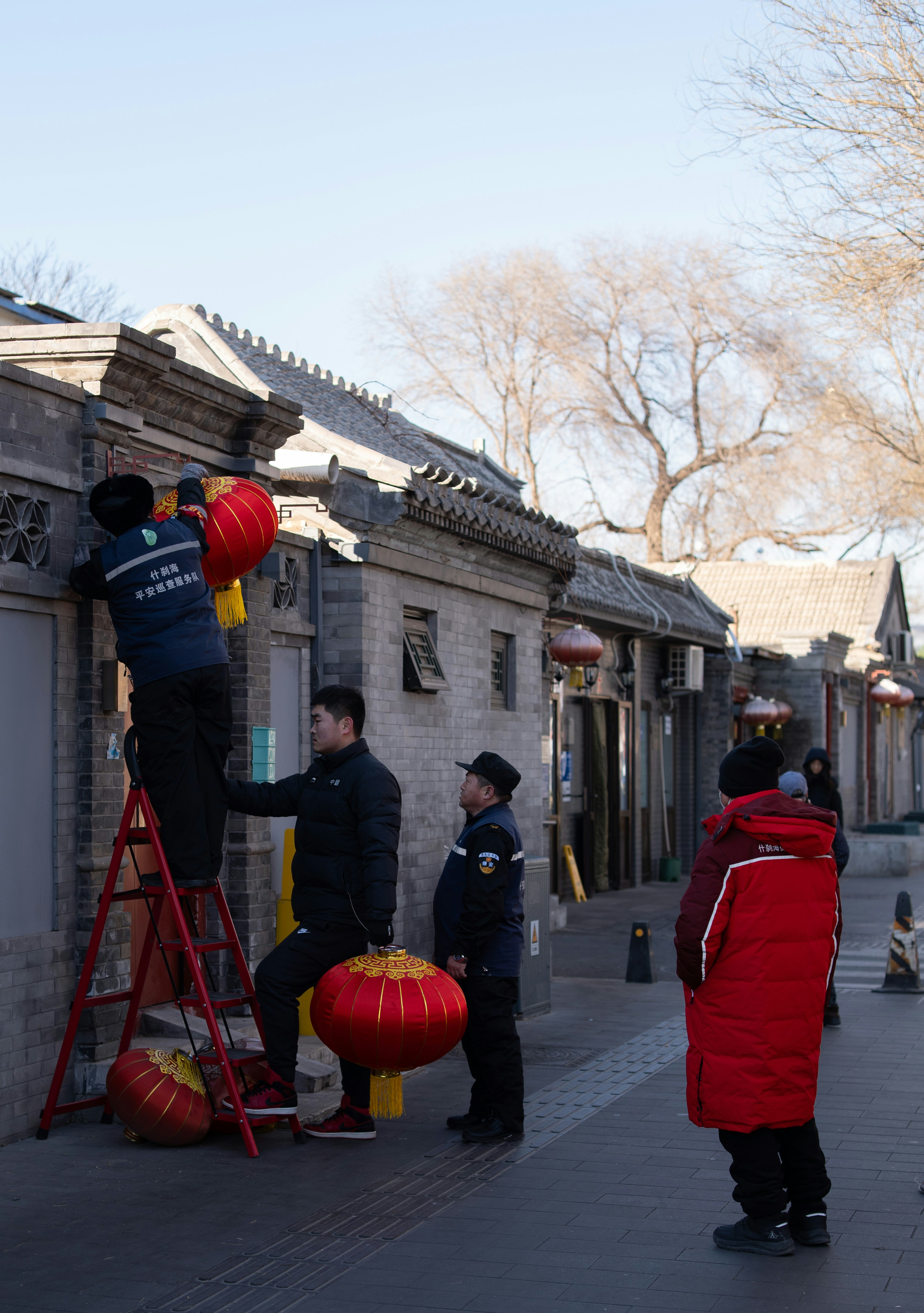A group of people standing next to each other on a sidewalk