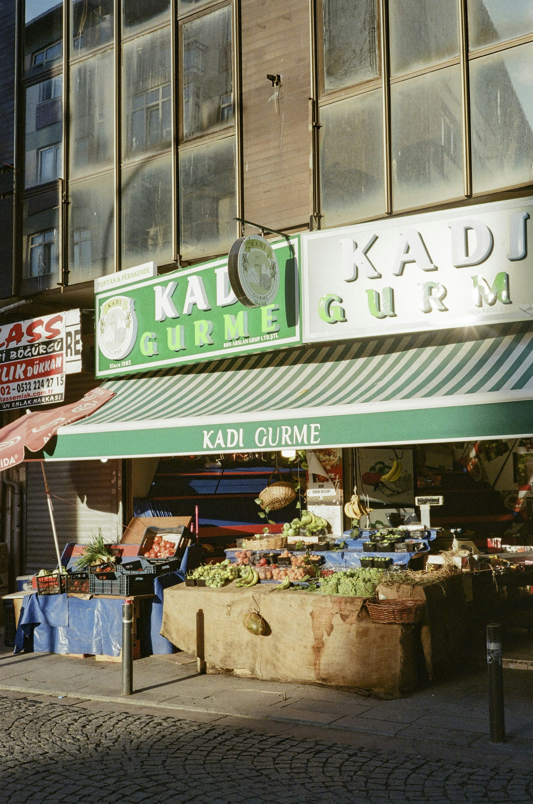 A man standing outside of a store next to a building