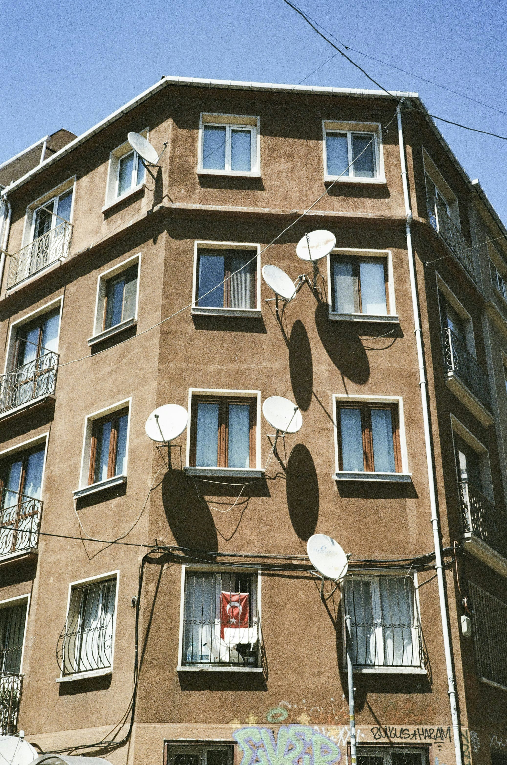 A tall brown building with lots of windows