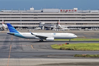 A large jetliner sitting on top of an airport tarmac