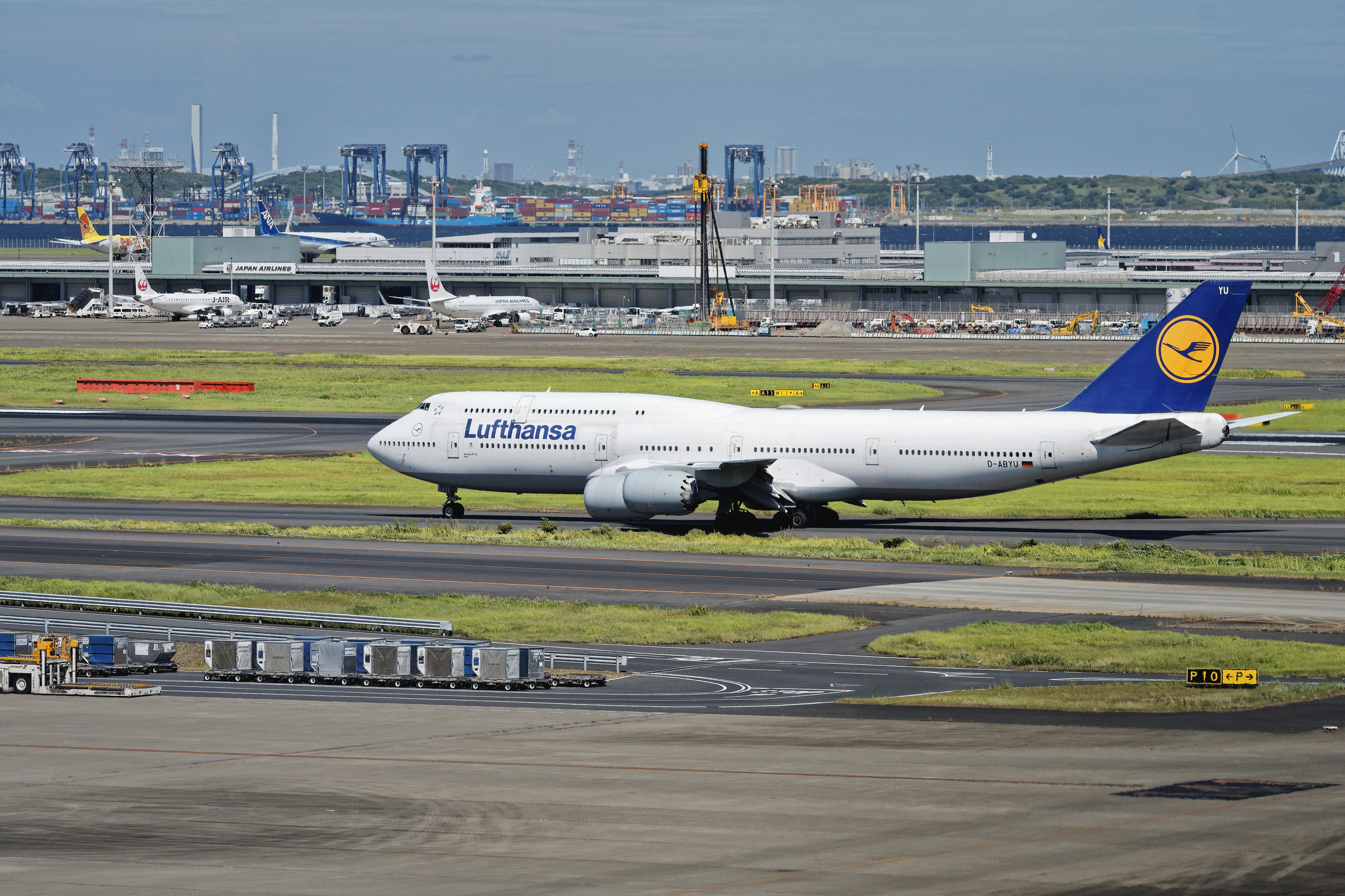 A large jetliner sitting on top of an airport runway, 