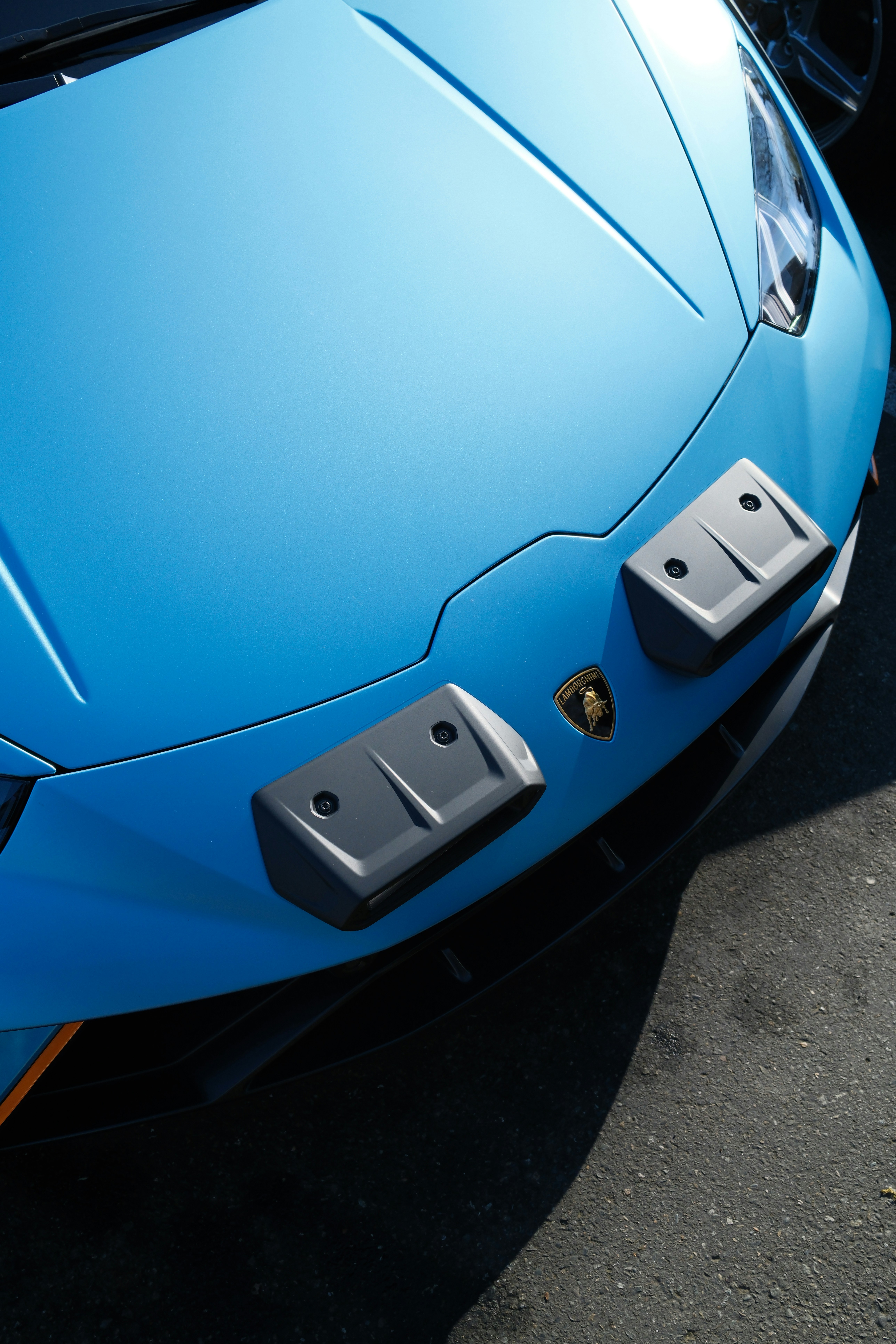 A blue sports car parked in a parking lot