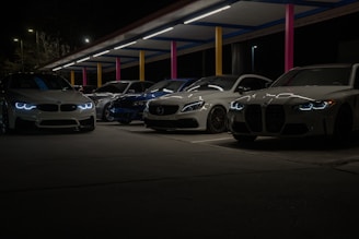 A row of cars parked next to each other in a parking lot