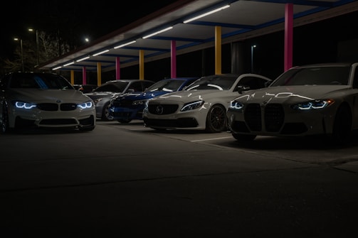 A row of cars parked next to each other in a parking lot