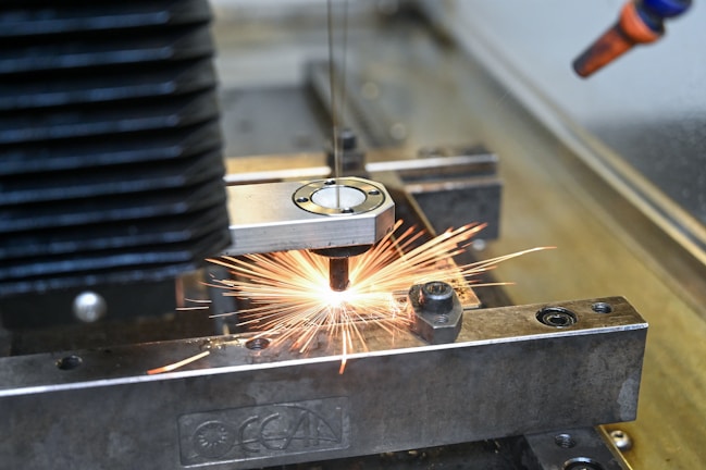A machine cutting a piece of metal with a grinder
