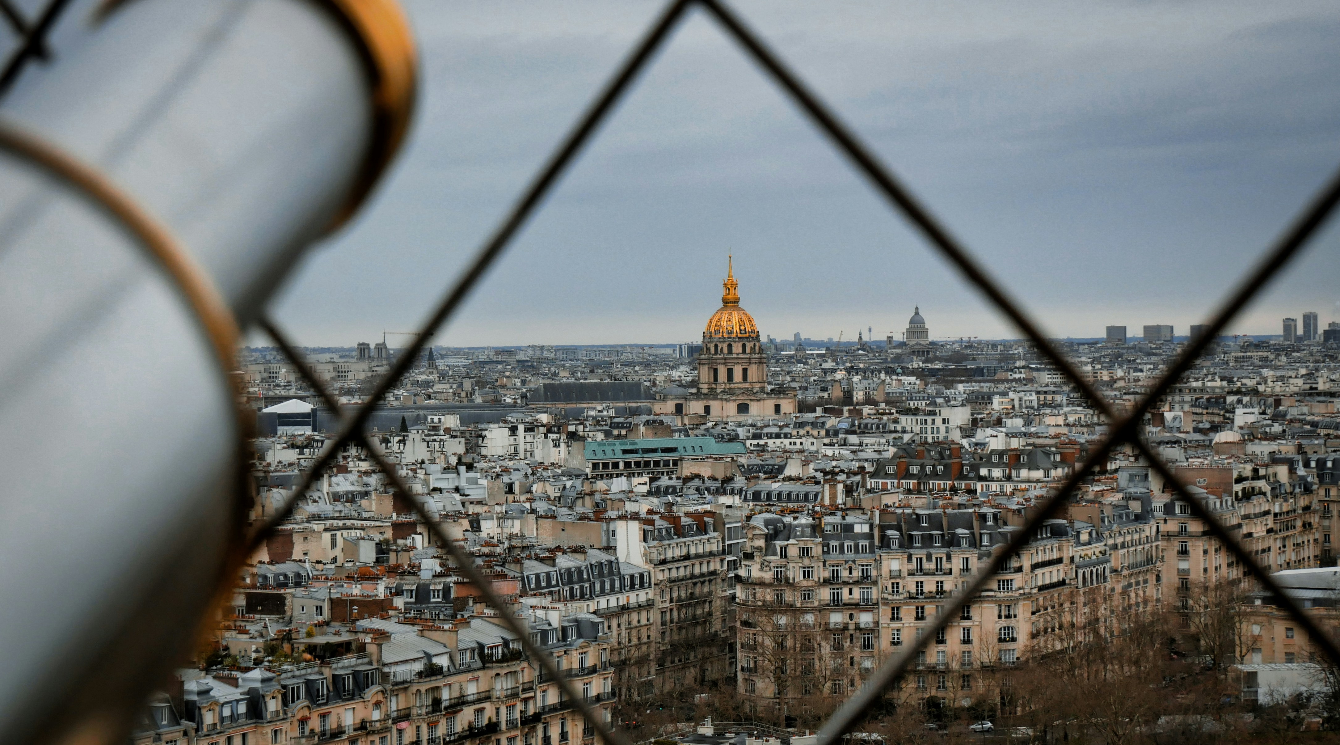 A view of a city through a fence