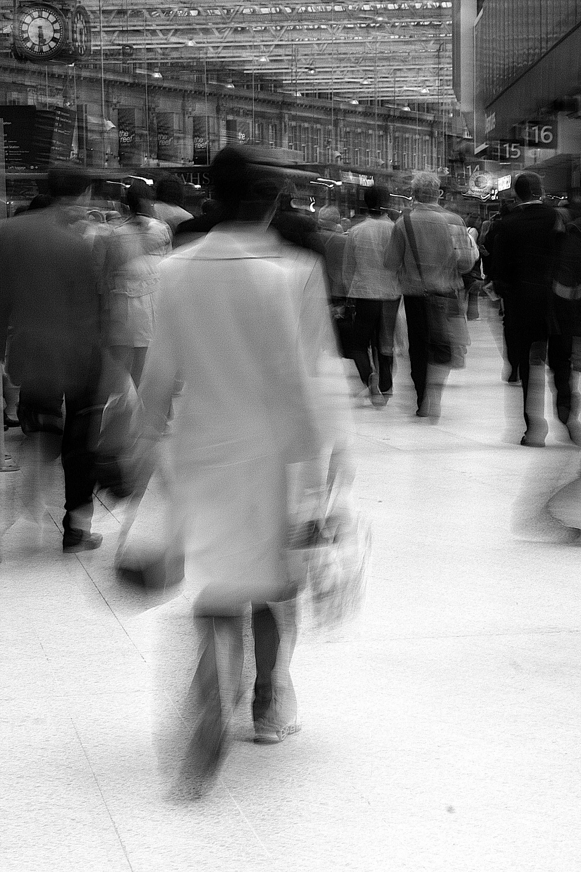 A group of people walking down a street